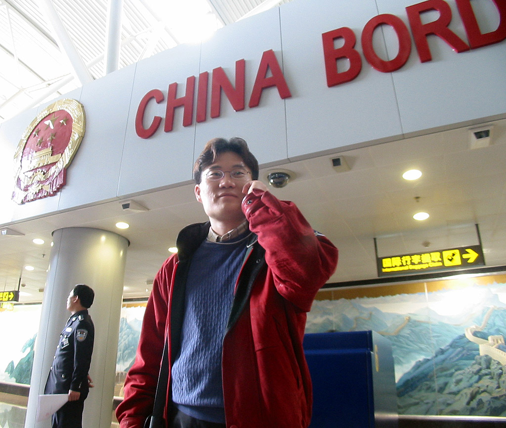 SK Telecom customers are making calls using CDMA automatic roaming service at the arrival gate of Beijing Airport and in Downtown of Beijing.